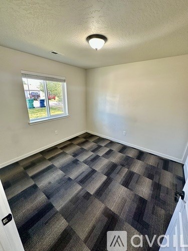 A spacious garage with a concrete floor and white walls.