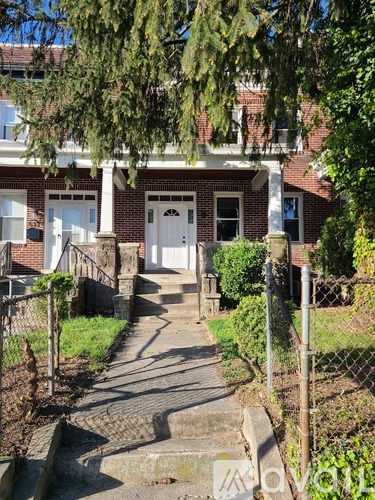 A house with a white door and a small porch.