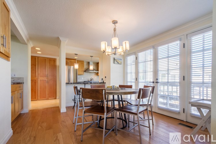 A kitchen with a dining table and chairs.