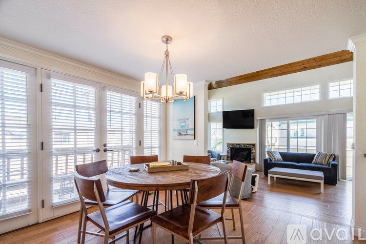 A dining room with a wooden table and chairs.