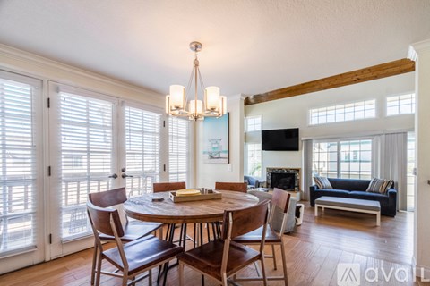 A dining room with a wooden table and chairs.