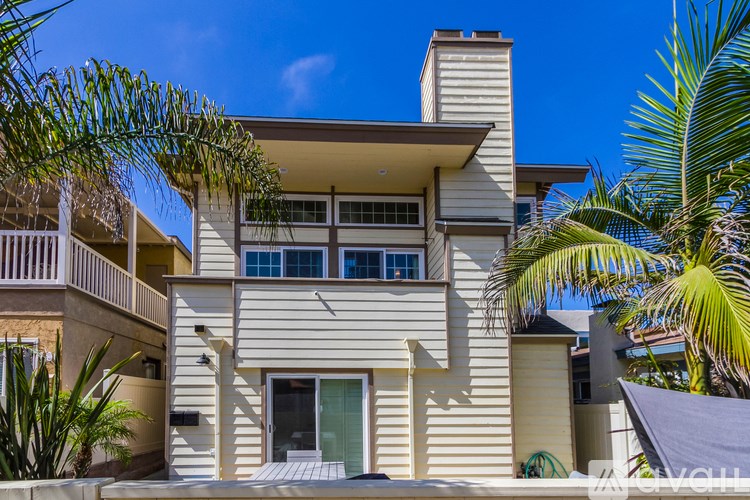 A modern house with a balcony and a chimney.