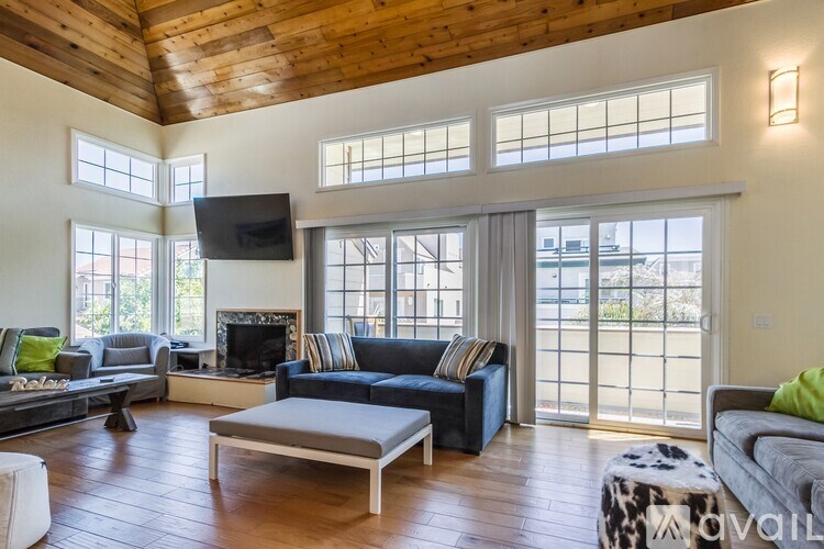 A living room with a flat screen TV mounted on the wall.