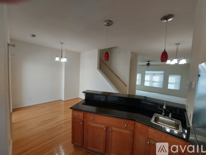A kitchen with wooden cabinets and a black countertop.