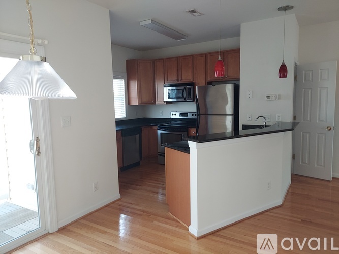 A kitchen with wooden cabinets and a white island.
