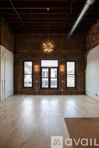 A room with wooden floors and a large window.