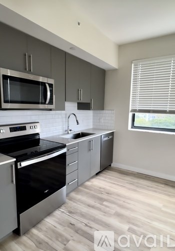 A kitchen with a stove top oven and microwave.