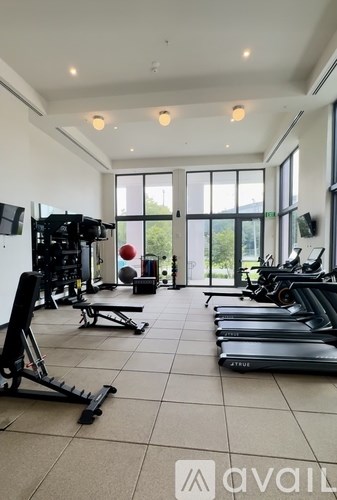 A gym with treadmills, weights, and exercise equipment.