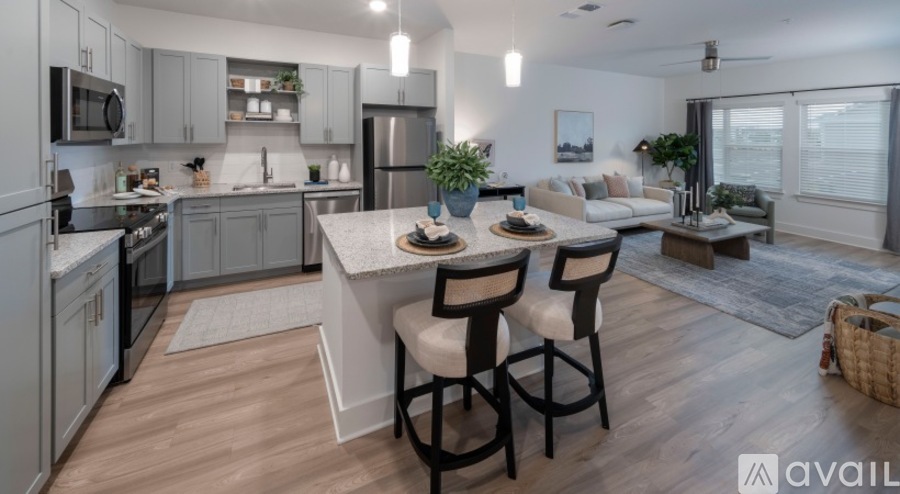 A modern kitchen with a dining area and a living room.