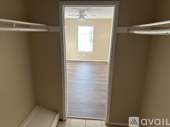 A small room with a toilet and a window.