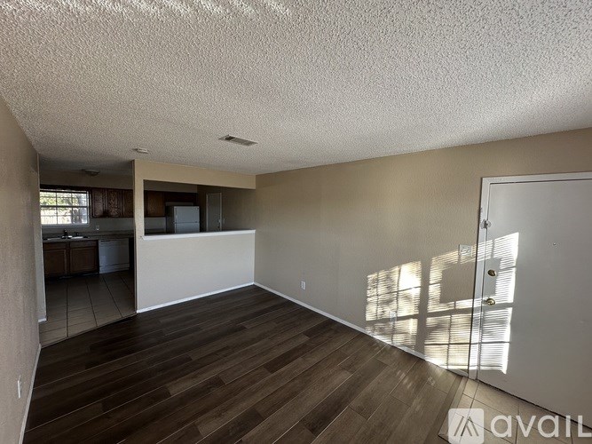 A room with wooden flooring and a white ceiling.