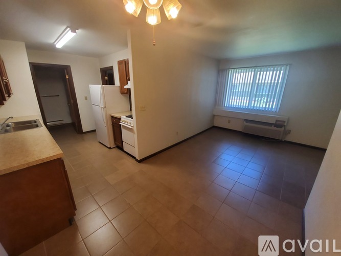 A room with wooden flooring and a window.
