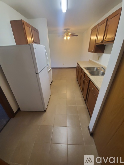 A kitchen with wooden floors and a granite counter top.