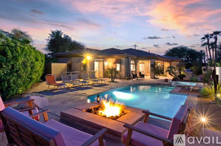 A house with a pool and a fire pit in the backyard.