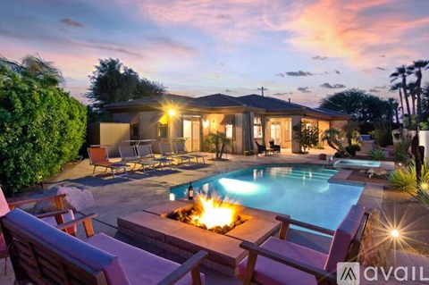 A house with a pool and a fire pit in the backyard.