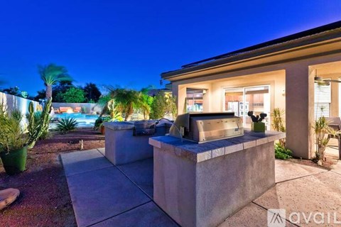 A house with a driveway and a hot tub in the front yard.