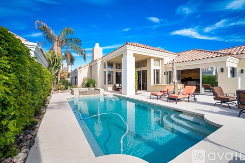 A large house with a pool in the backyard.
