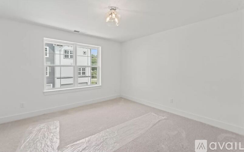 A room with a large window and a white floor.