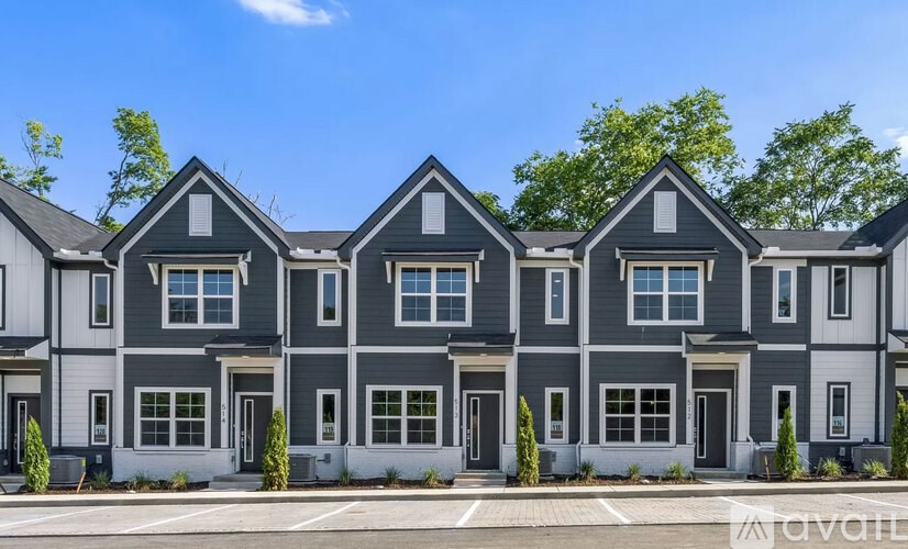 A row of houses with grey and white exteriors.