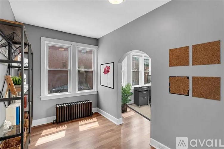 A room with a grey wall and a white cabinet.