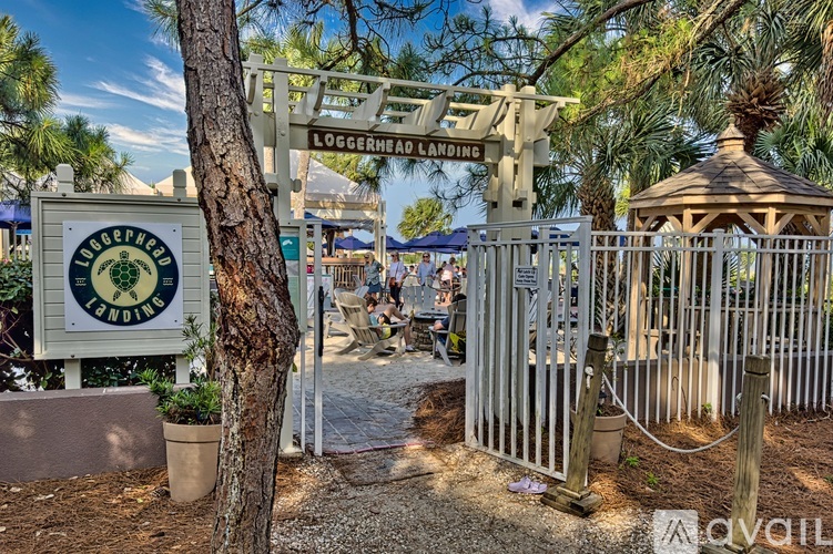 A sign that says "Loggerhead Landing" is in front of a gazebo.