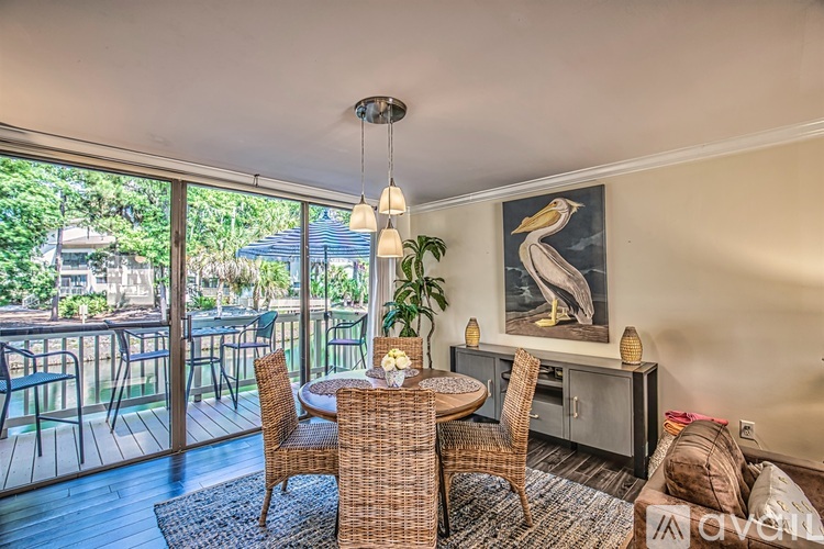 A living room with a dining table and chairs.