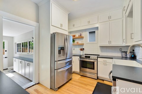 A kitchen with white cabinets and stainless steel appliances.