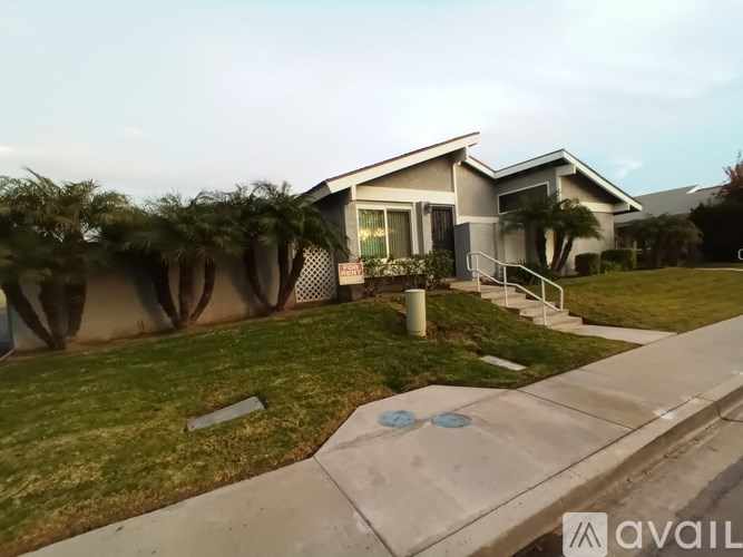 A house with a front yard and a driveway.