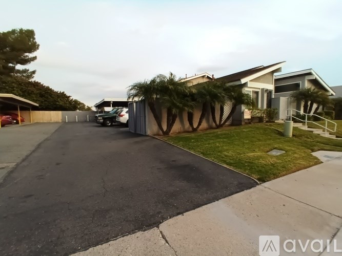 A house with a driveway and a car parked in front.