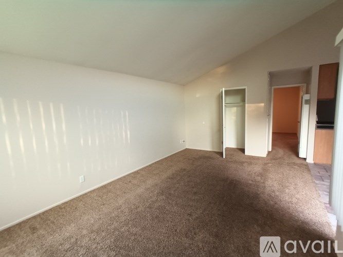 A room with carpeted floor and white walls.