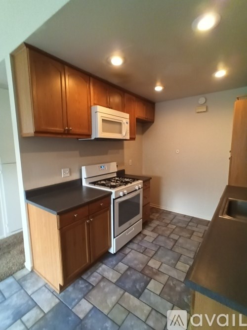 A kitchen with a stove top oven and microwave above it.