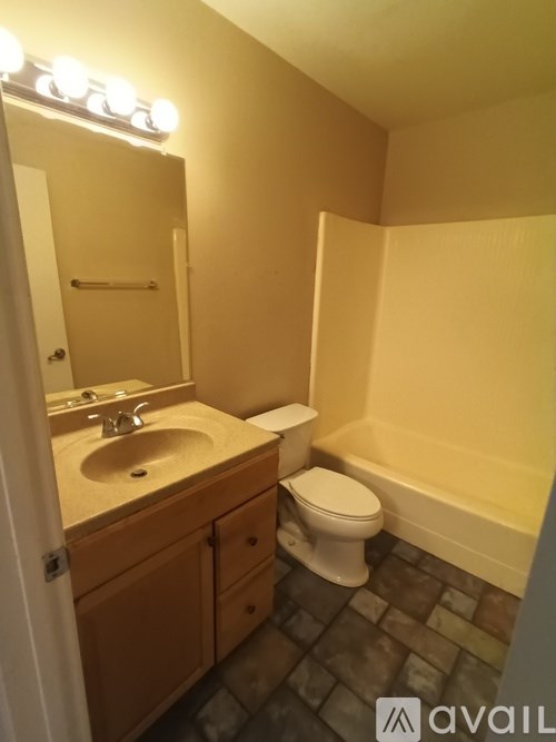 A bathroom with a sink, toilet and bathtub.