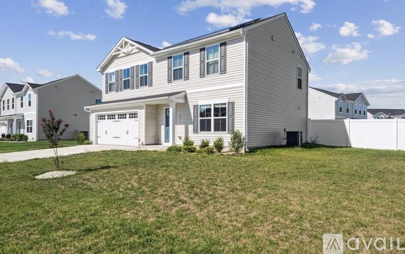 A house with a garage is for sale.