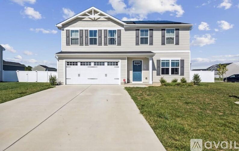 A two-story house with a garage is for sale.