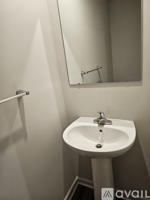 A white sink in a small bathroom.