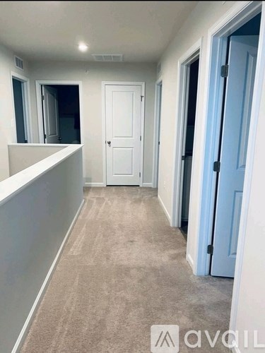 A hallway with a white door and a blue door.
