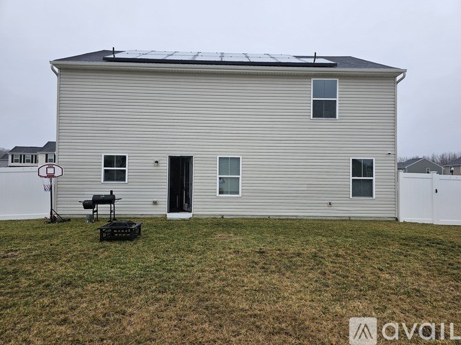 A house with a solar panel on the roof.