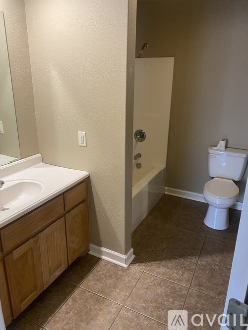 A bathroom with a toilet, sink, and bathtub.
