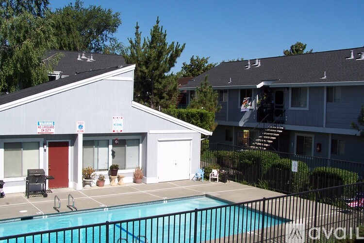 A pool in front of a building with a sign that says "Avalon".