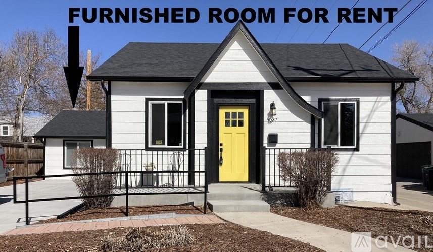 A bedroom with a bed, window, and a lamp is available for rent.