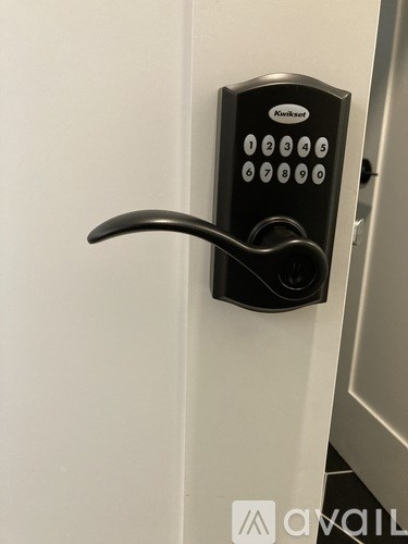 A door handle with a keypad lock attached to it.