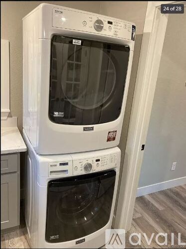 A white washer and dryer stacked on top of each other.