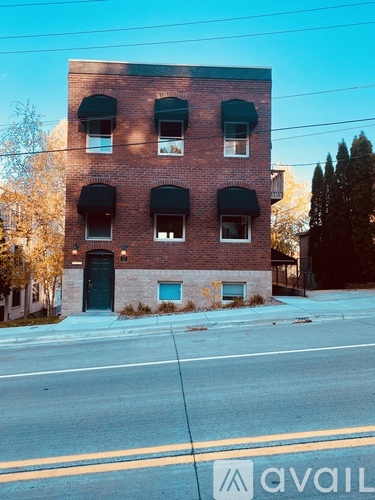 A red brick building with a black door and windows.