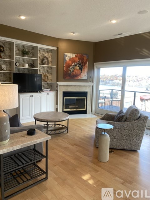 A living room with a fireplace and a painting on the wall.