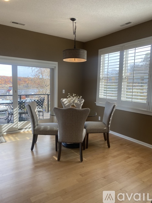 A dining room with a table set for four.