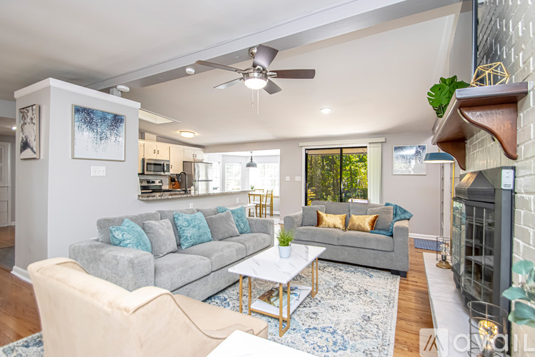 A living room with a grey couch and a coffee table.