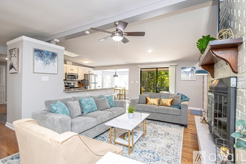 A living room with a grey couch and a coffee table.