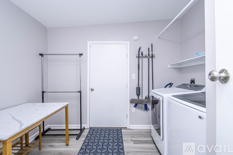 A small kitchen with a washing machine and a table.
