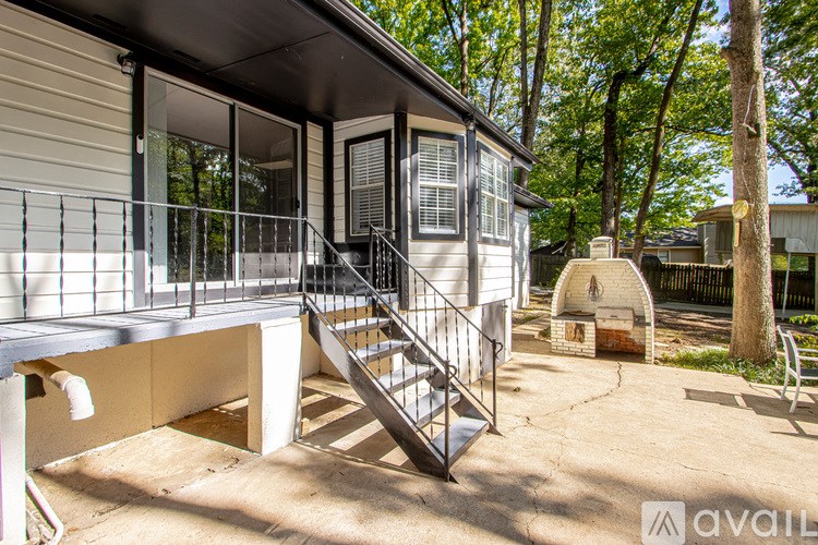 A house with a metal staircase leading to a balcony.