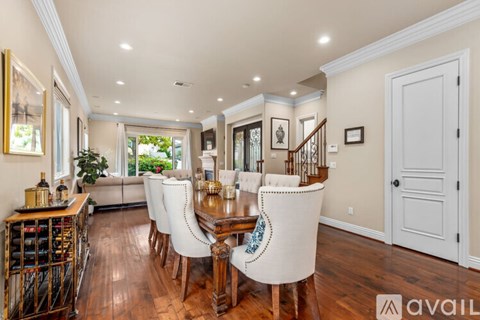 A dining room with a wooden table and chairs.